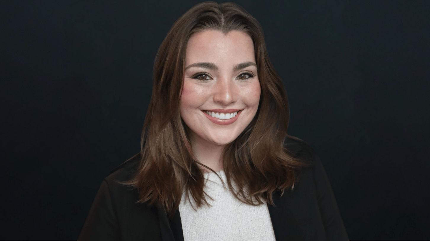 Portrait of Loyola University Chicago student smiling against black background